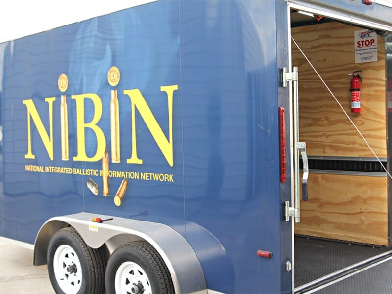 Photo of a utility trailer with NIBIN which stands for National Integrated Ballistic Information Network, written on the side.